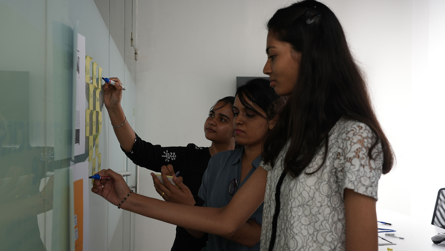 Team collaborating on whiteboard strategy